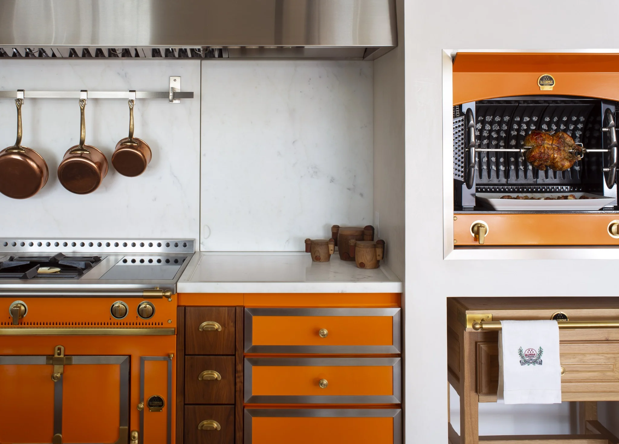 La Cornue orange range with brass accents in a custom luxury kitchen