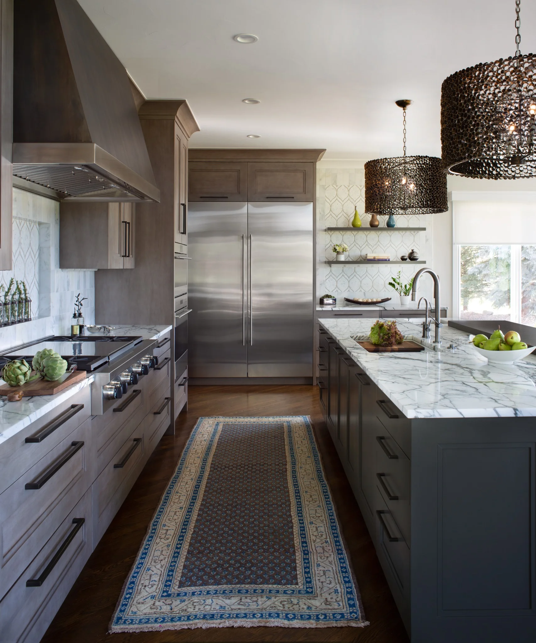 luxury kitchen with stainless steel appliances, marble countertops, and custom cabinetry